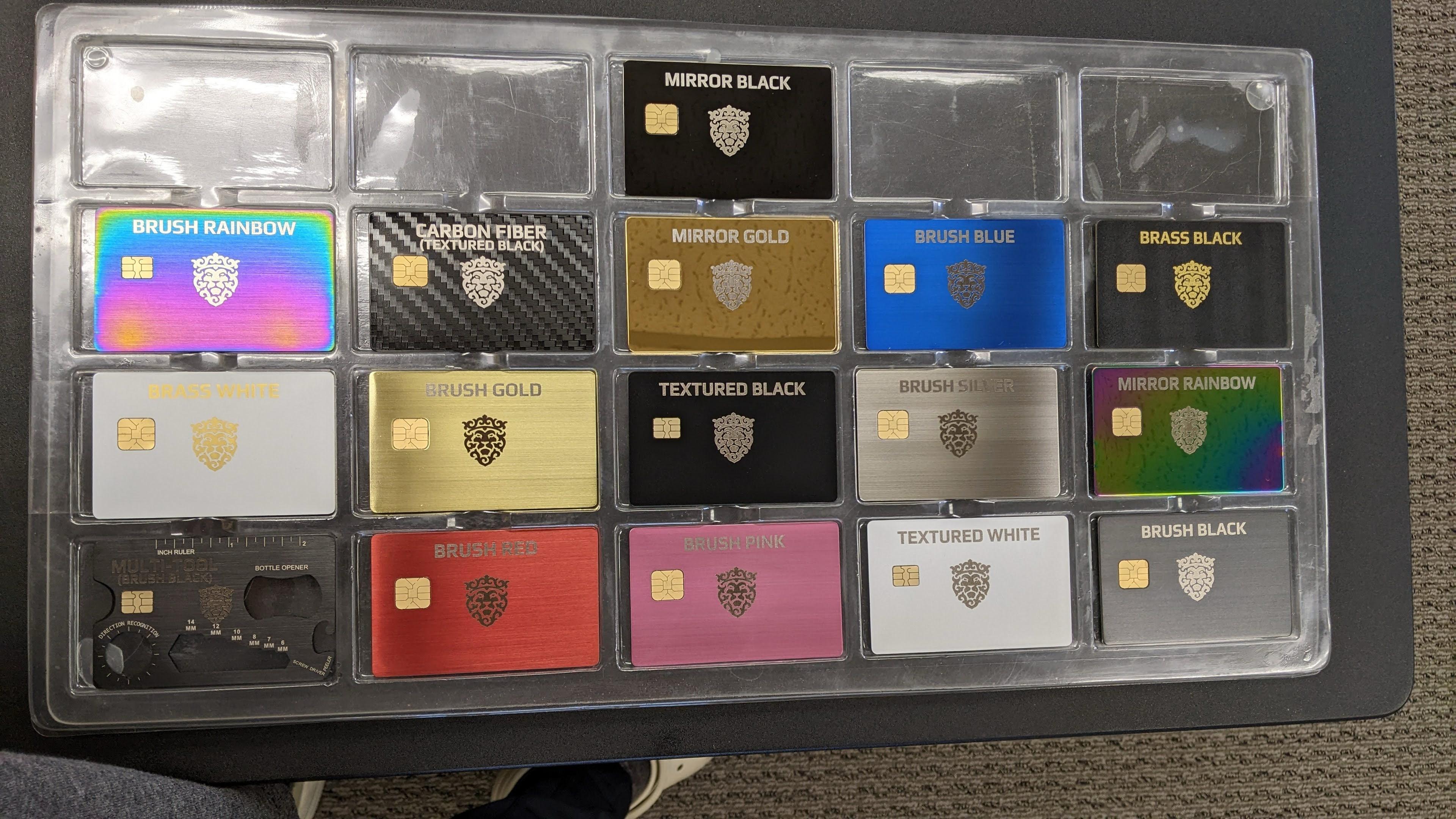 QFi Plus metal card color options — gold, rose gold, brushed silver, midnight black, and bronze finishes